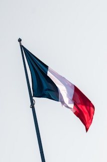 A red, white and blue flag flying in the wind