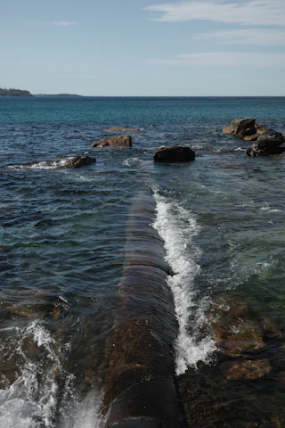 A large pipe sticking out of the water