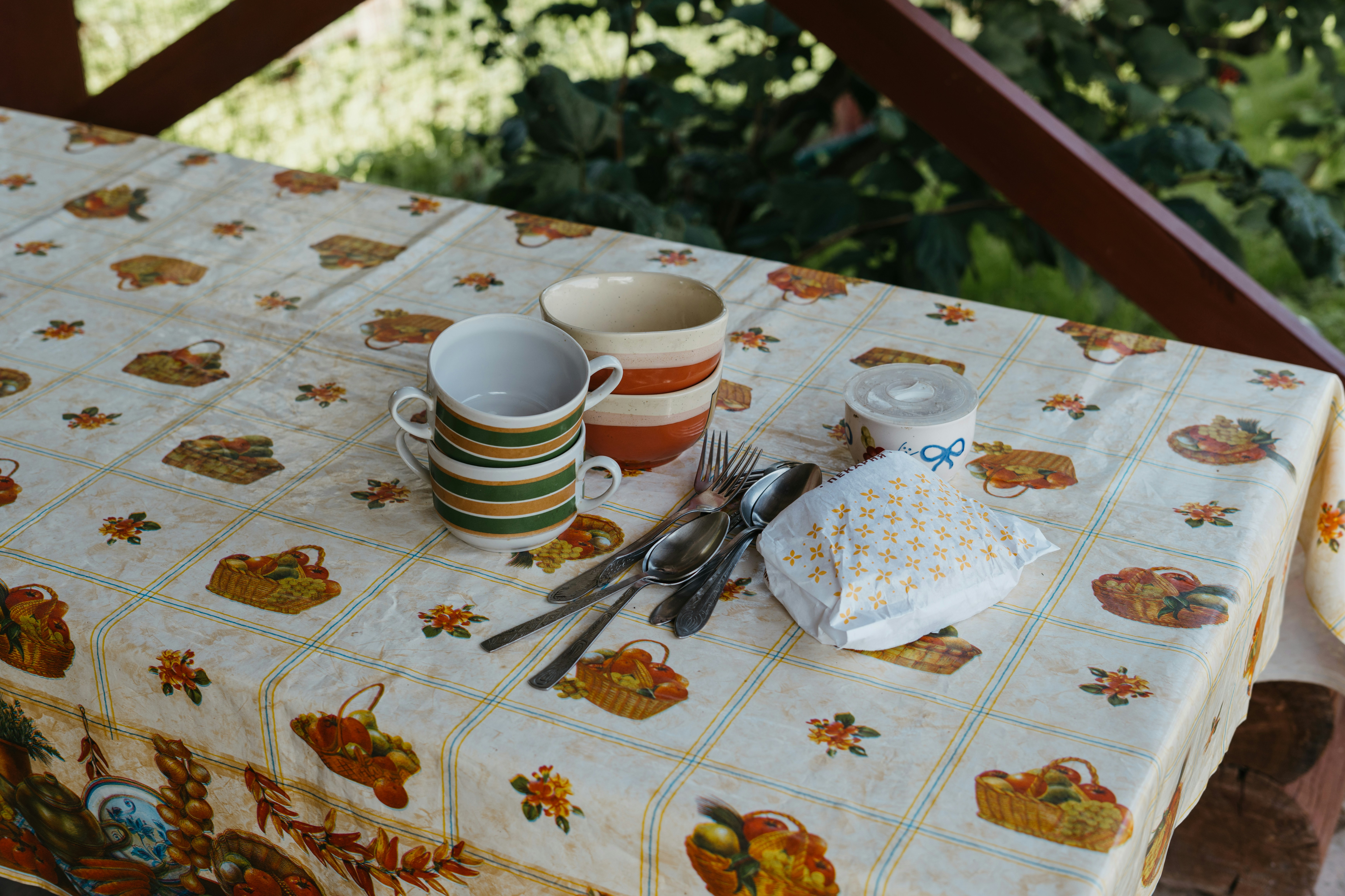 A table topped with cups and saucers on top of a wooden table