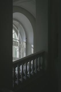 A staircase leading to a large window in a building