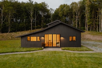 A small black house with a lot of windows