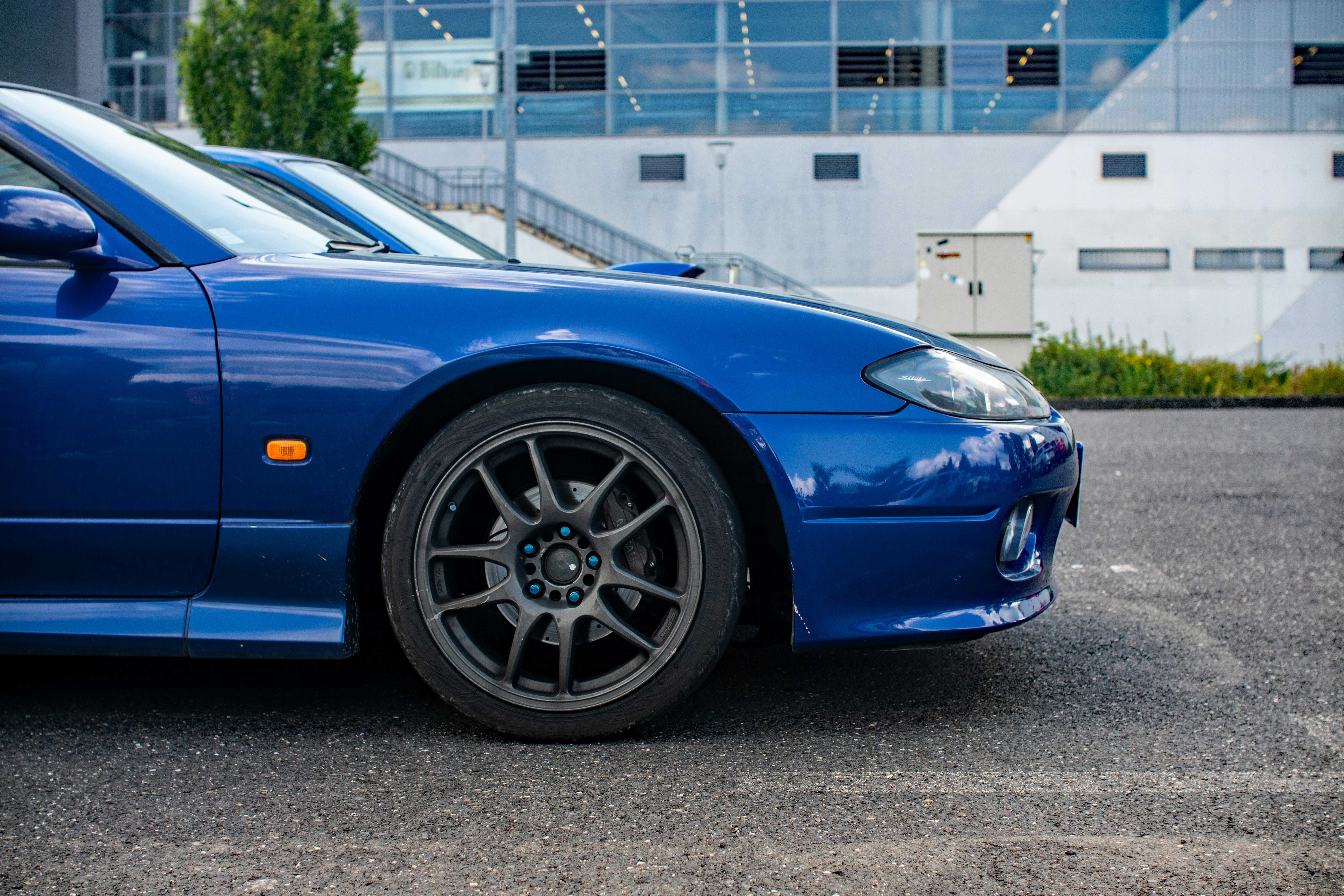 A blue sports car parked in a parking lot