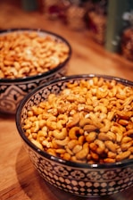 A couple of bowls filled with food on top of a wooden table