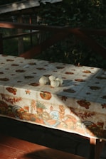 A table covered with a table cloth with mushrooms on it