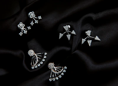 Three pairs of earrings on a black cloth