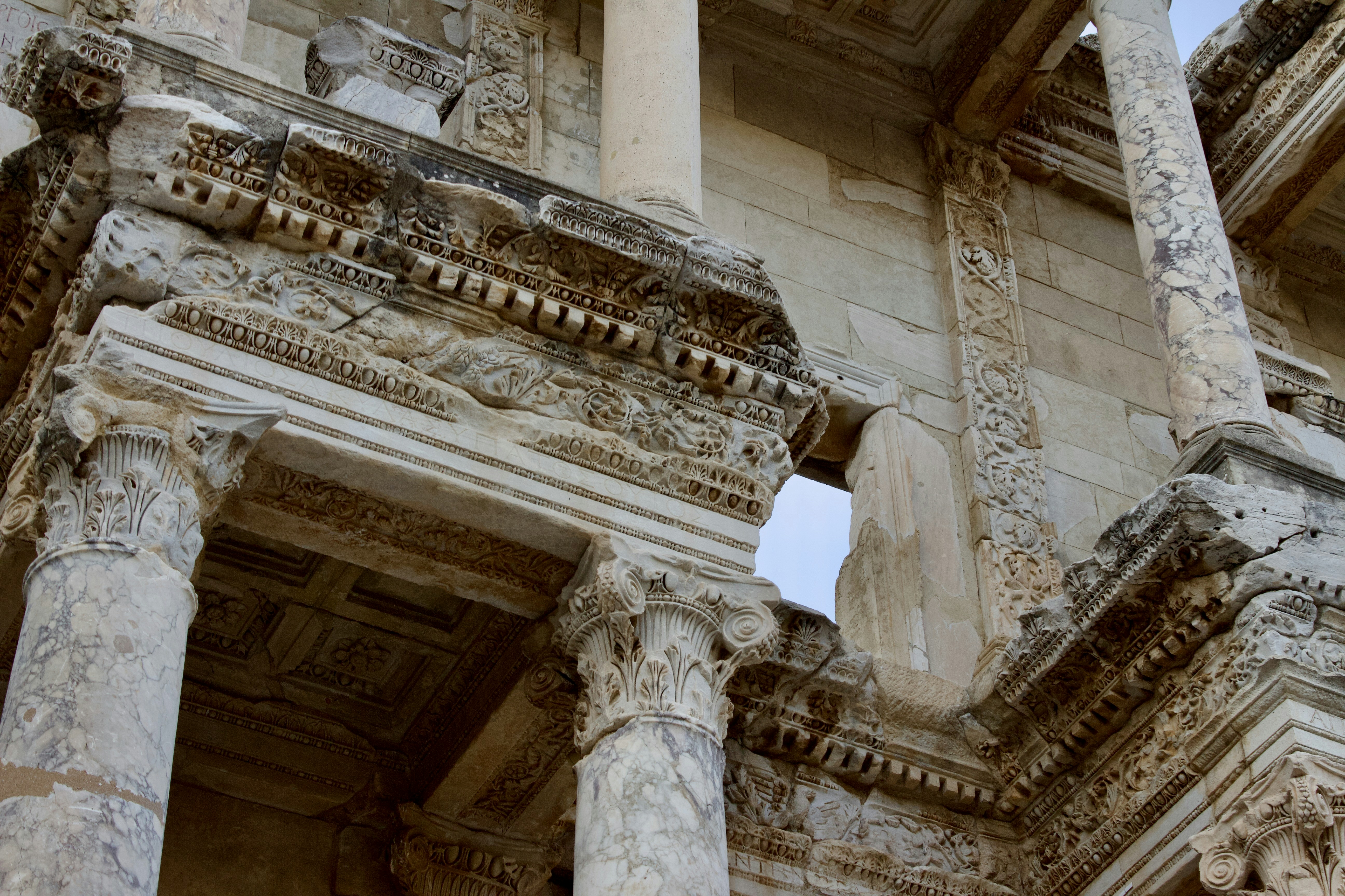A close up of a building with columns and a clock