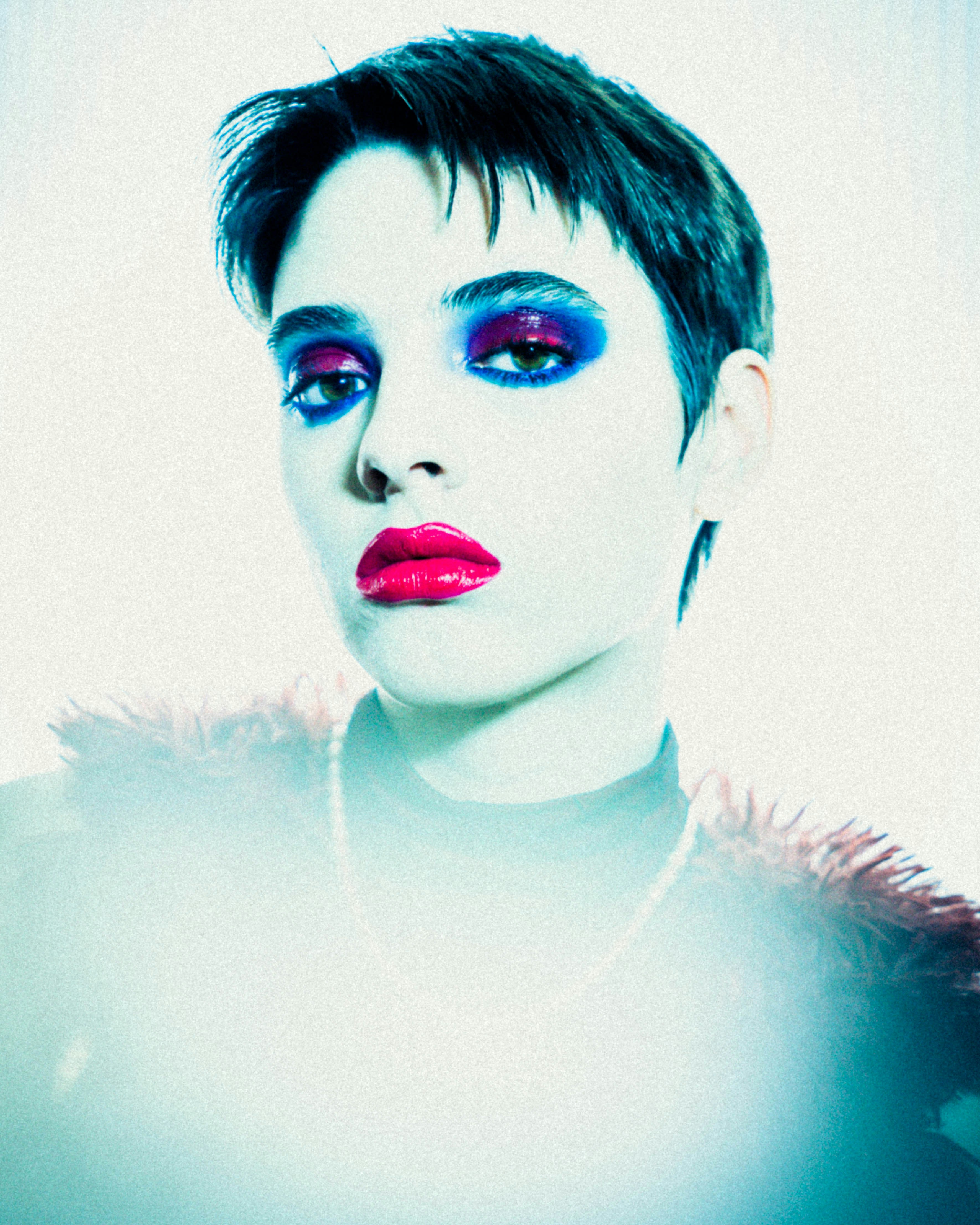 A woman with blue and pink makeup is posing for a picture photo – Free ...