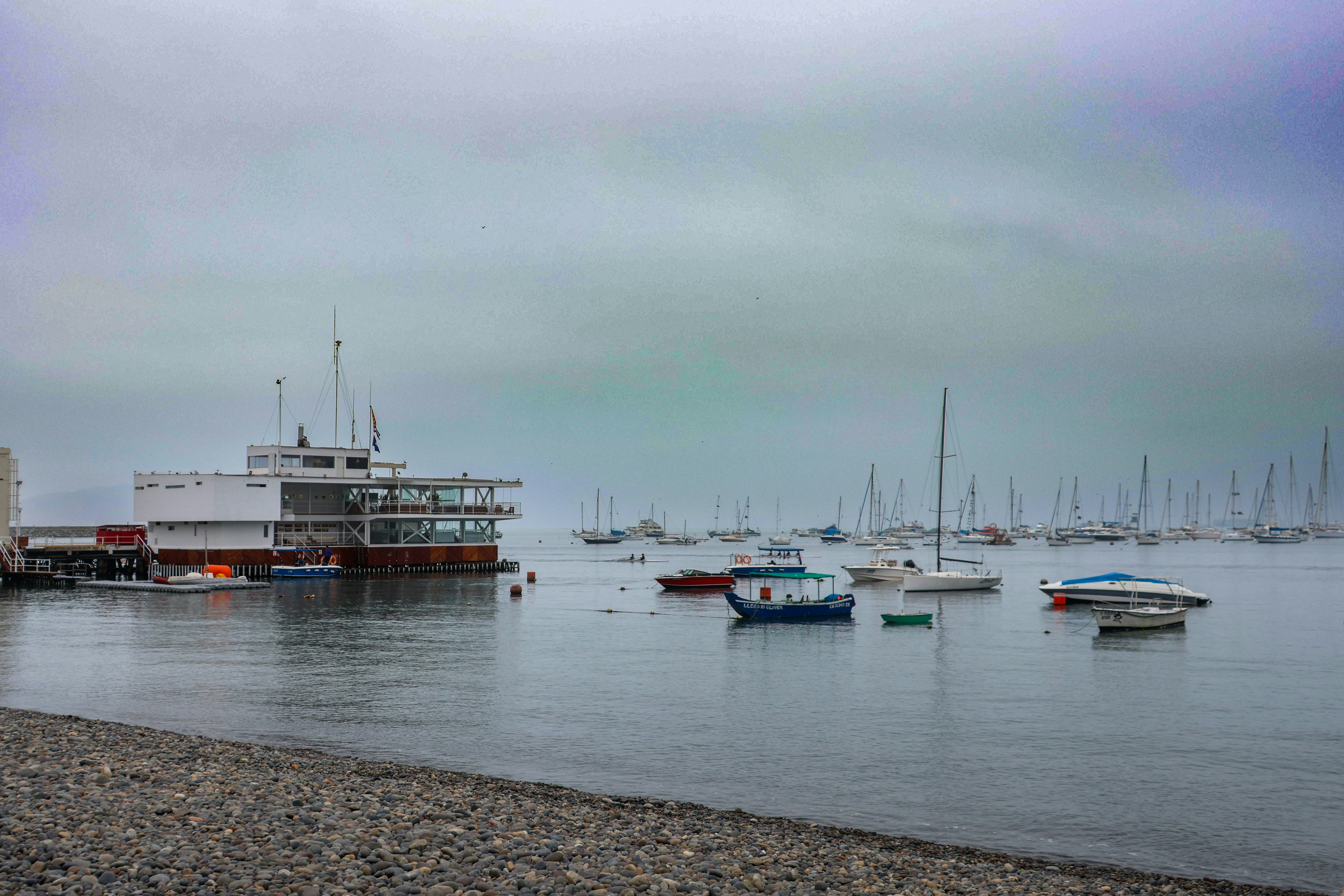 A group of boats floating on top of a body of water