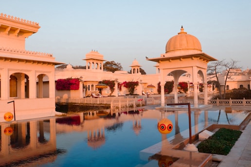 A large pool surrounded by white buildings