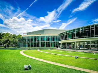 A large building with a grassy lawn in front of it