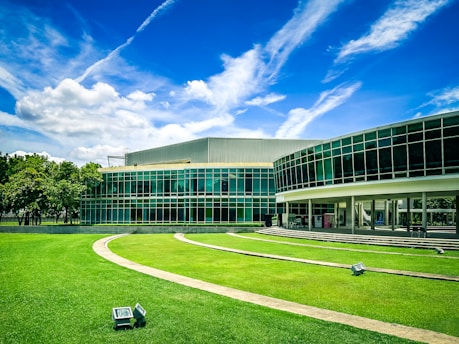 A large building with a grassy lawn in front of it