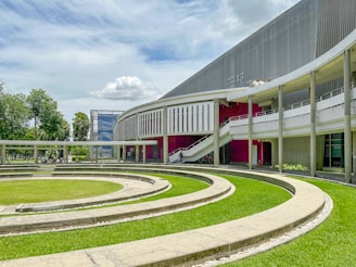 A large building with a circular lawn in front of it