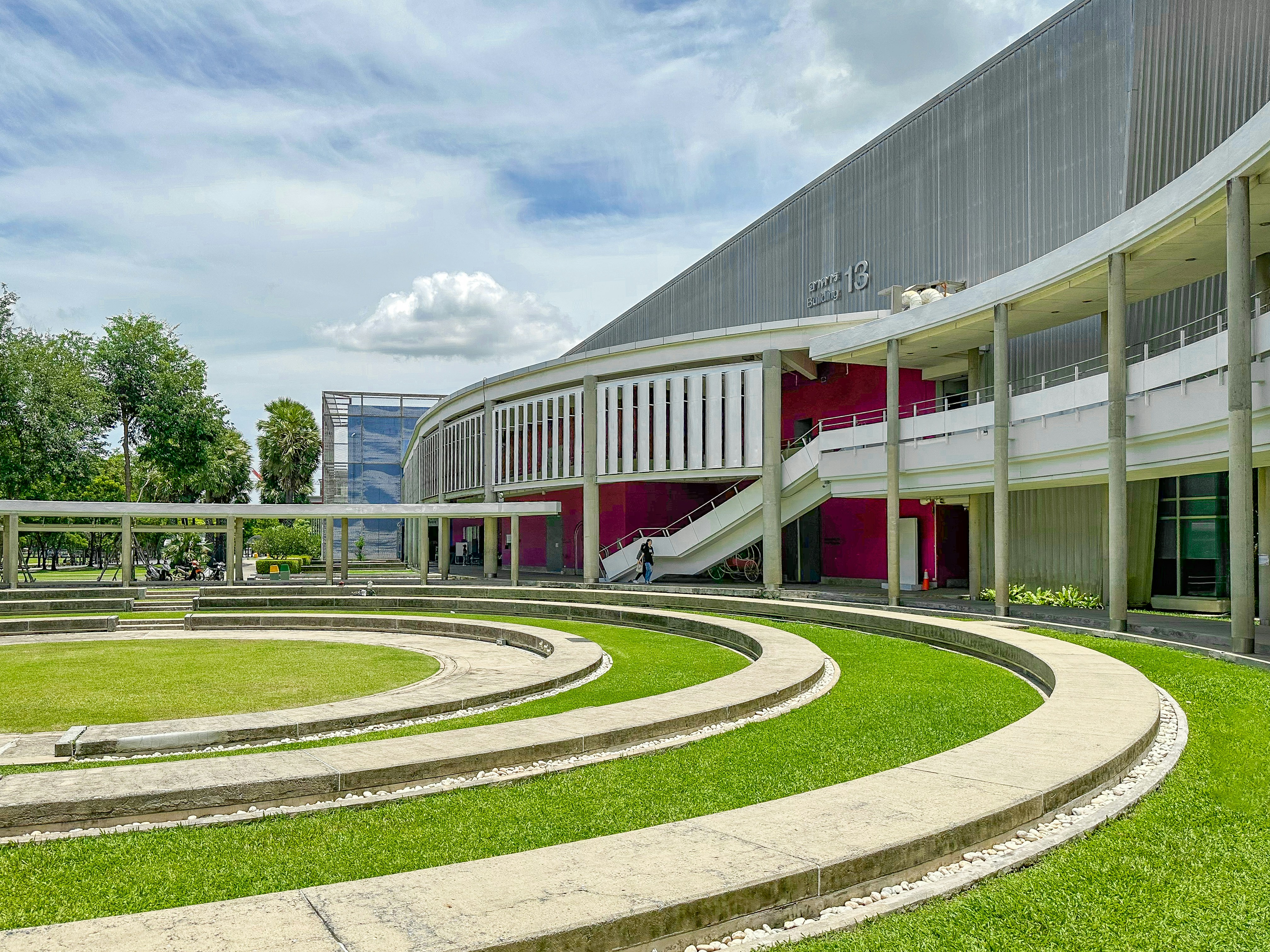 A large building with a circular lawn in front of it