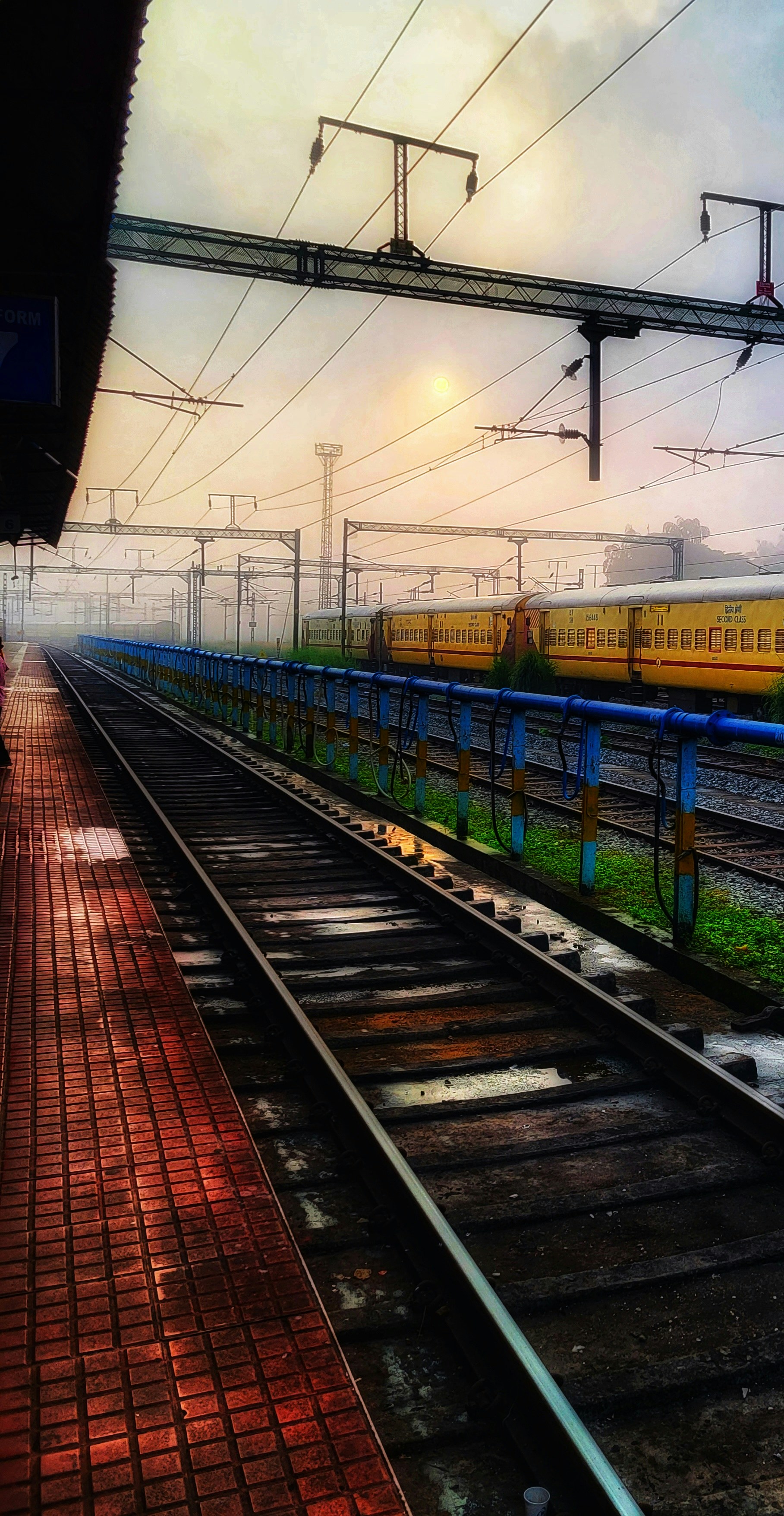A train traveling down train tracks next to a train station