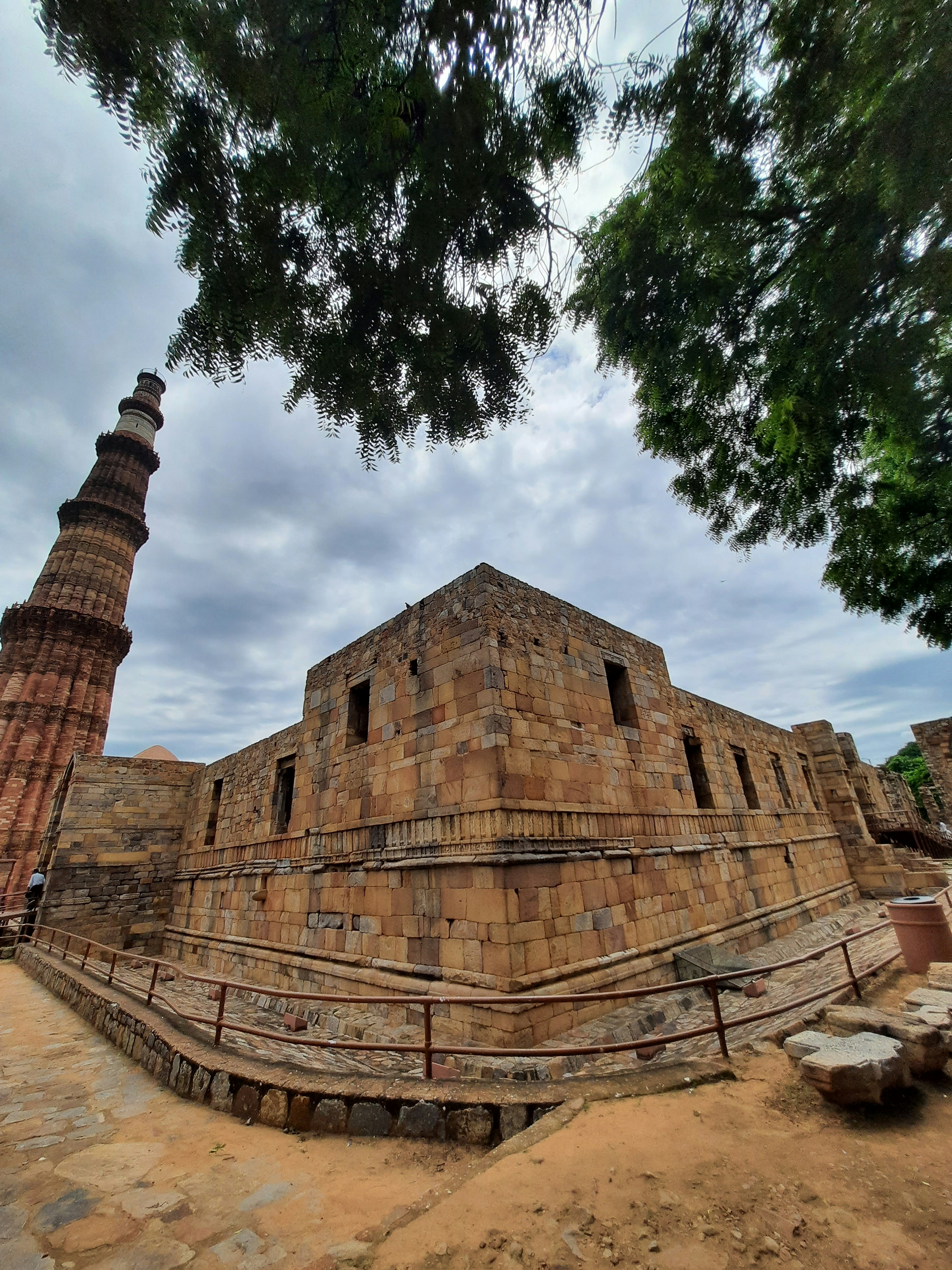 A large brick building sitting next to a tree