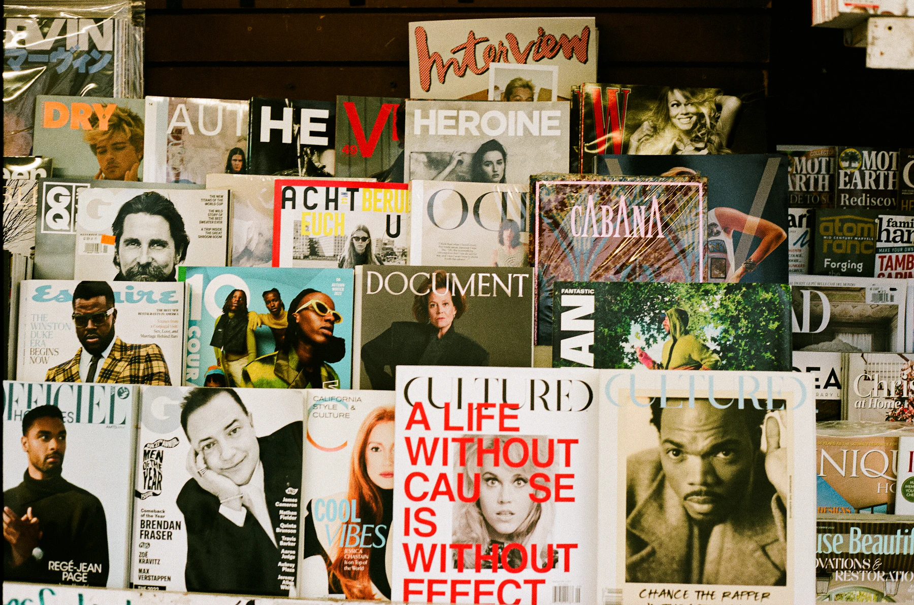 Rows of magazines displayed on a wall at a bookstore, spines and covers facing out