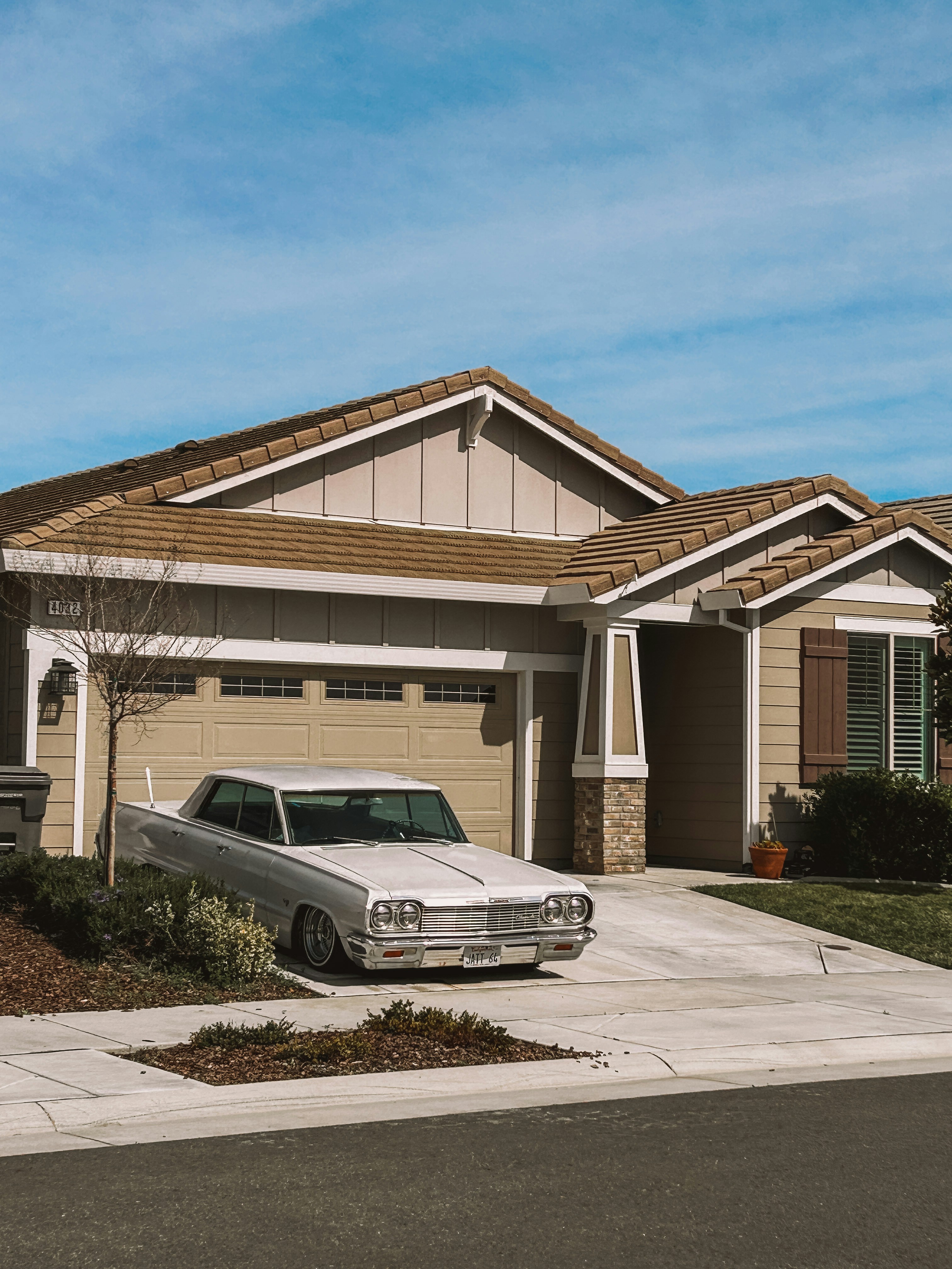 A white car parked in front of a house