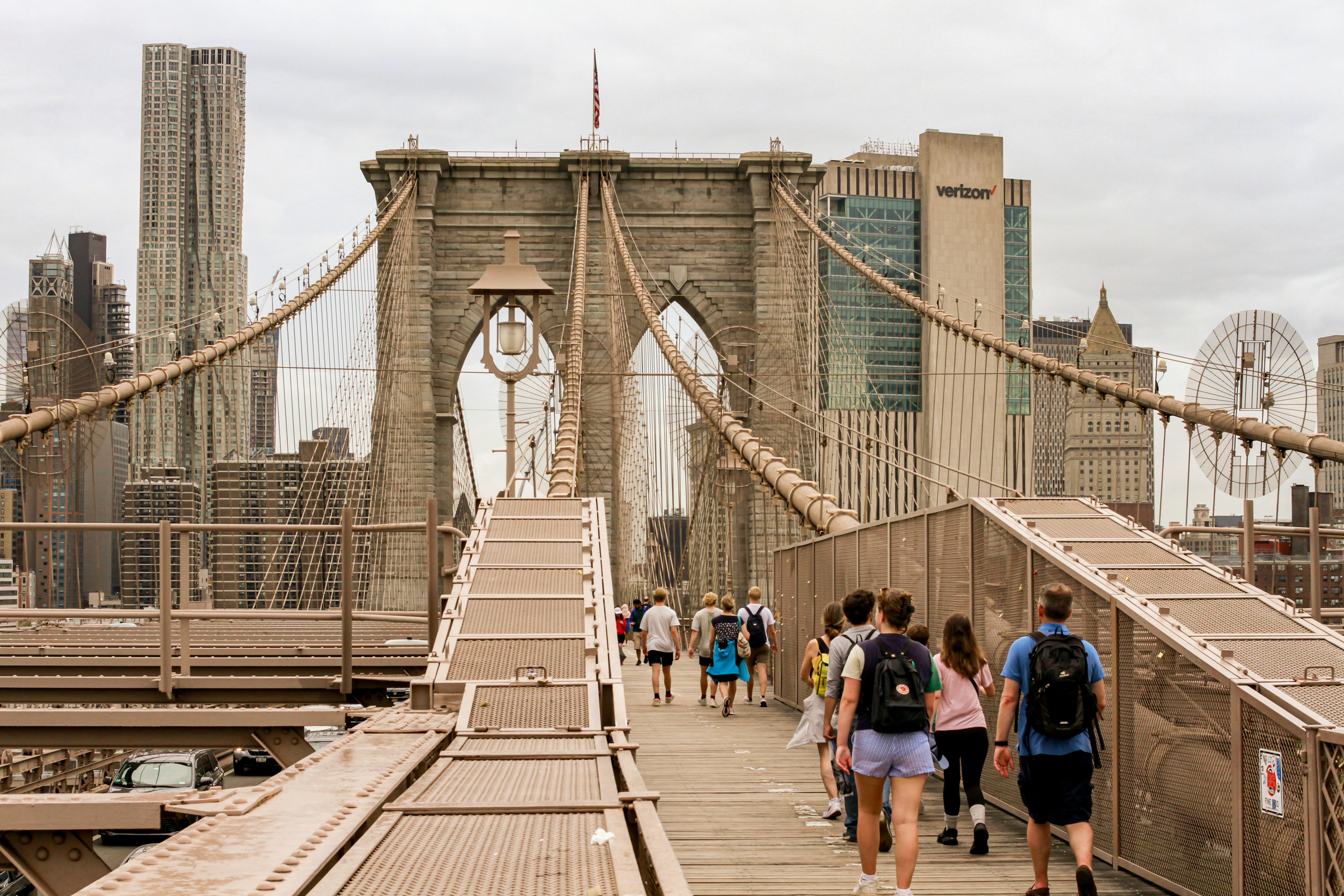 A group of people walking across a bridge