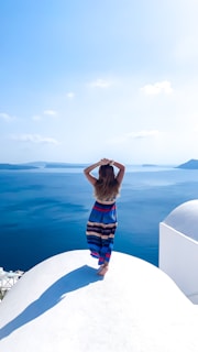 A woman standing on top of a white building