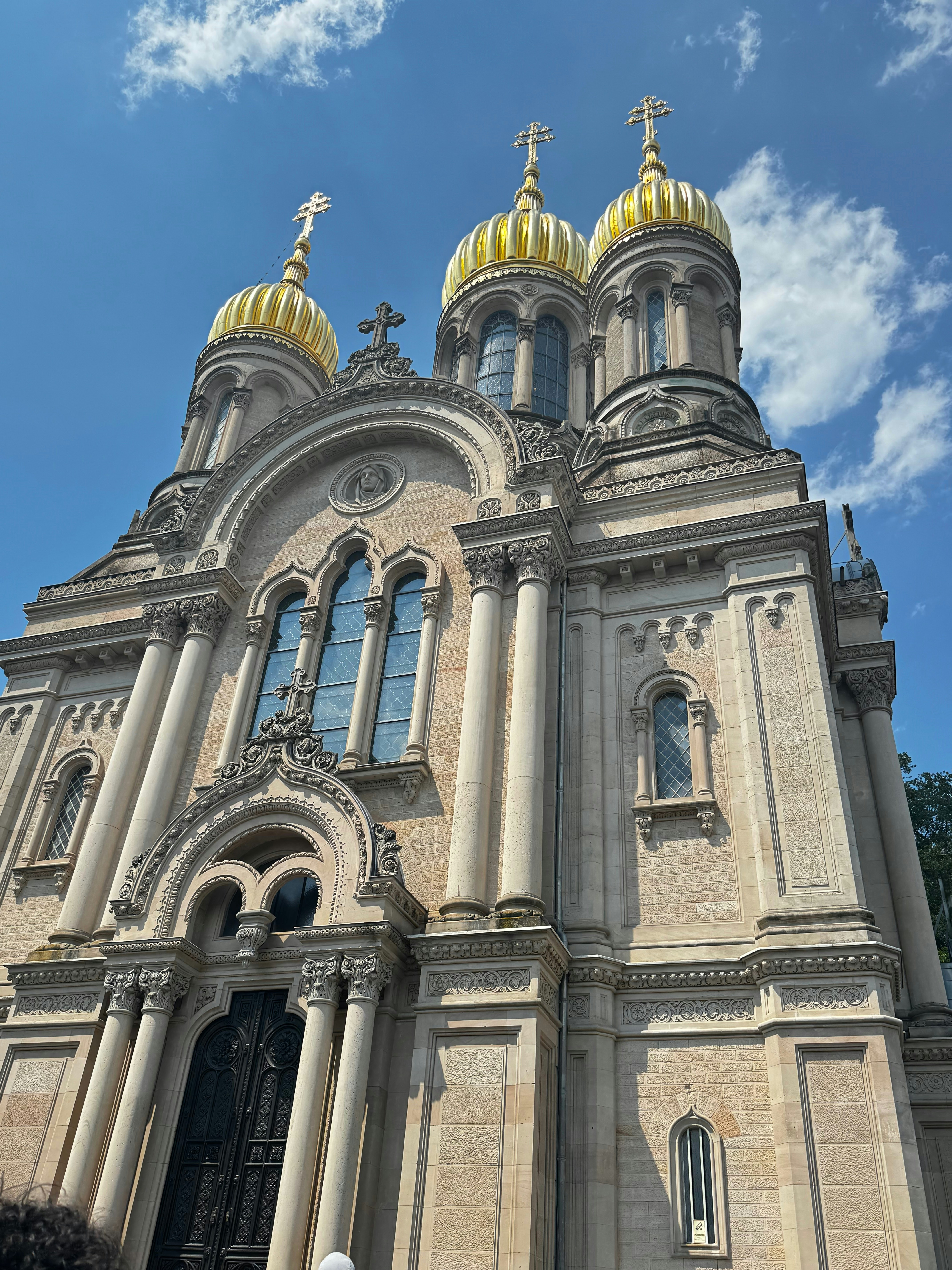 A large church with two golden domes on top of it