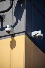 Two security cameras on the side of a building