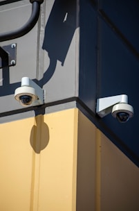 Two security cameras on the side of a building