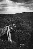 A black and white photo of a waterfall