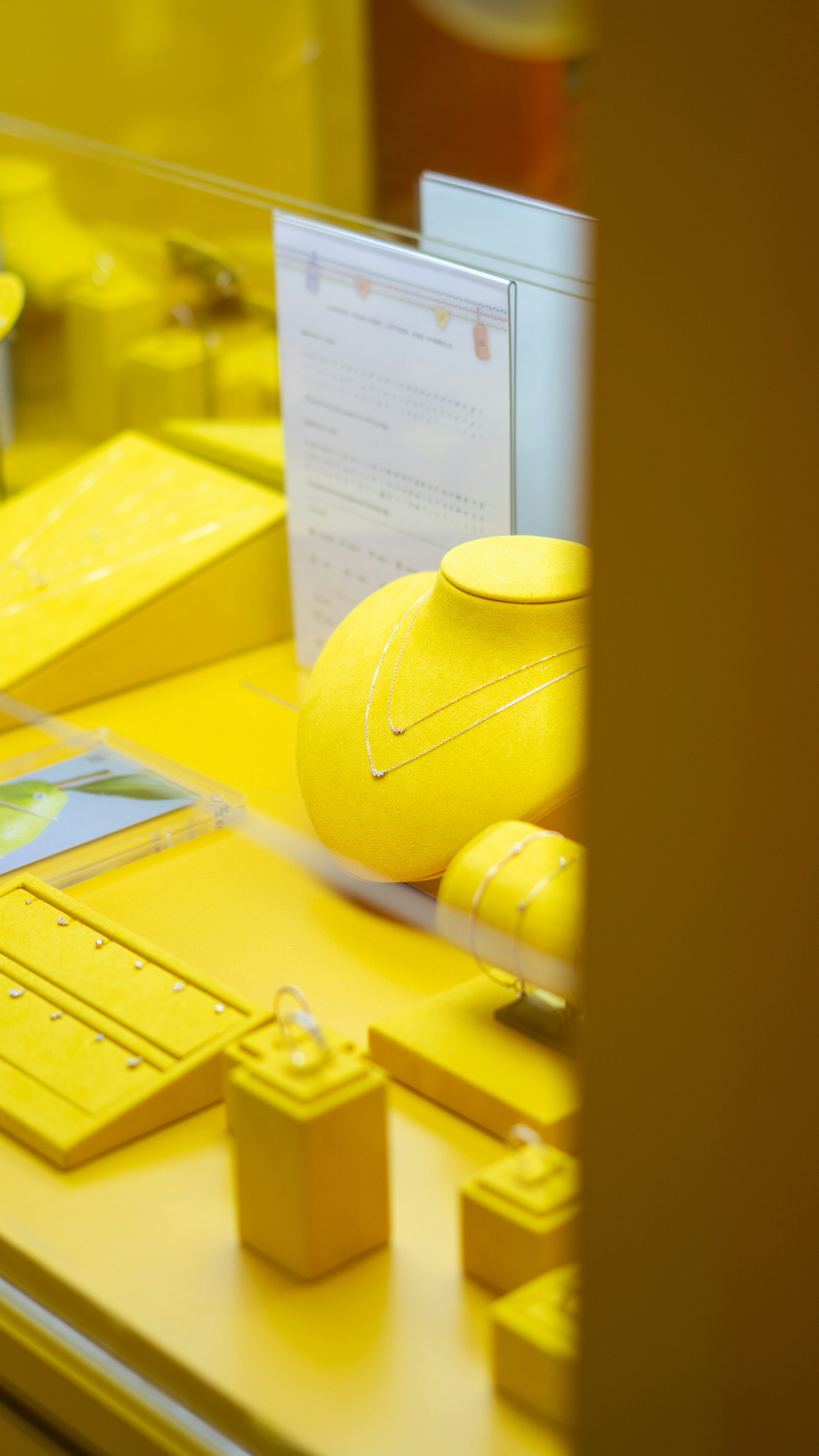 A yellow table topped with yellow vases and other items