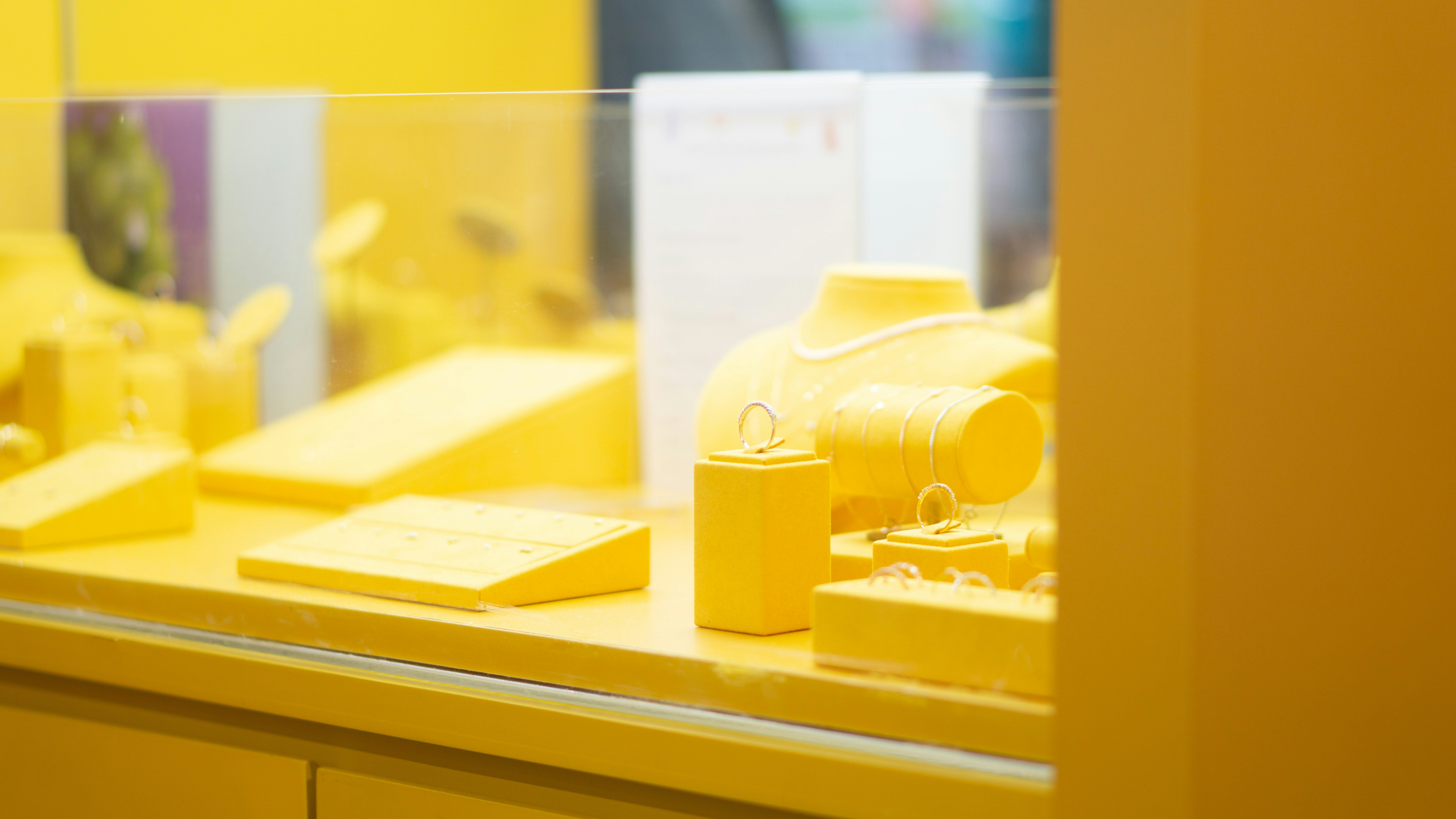A close up of a yellow fire hydrant on a shelf