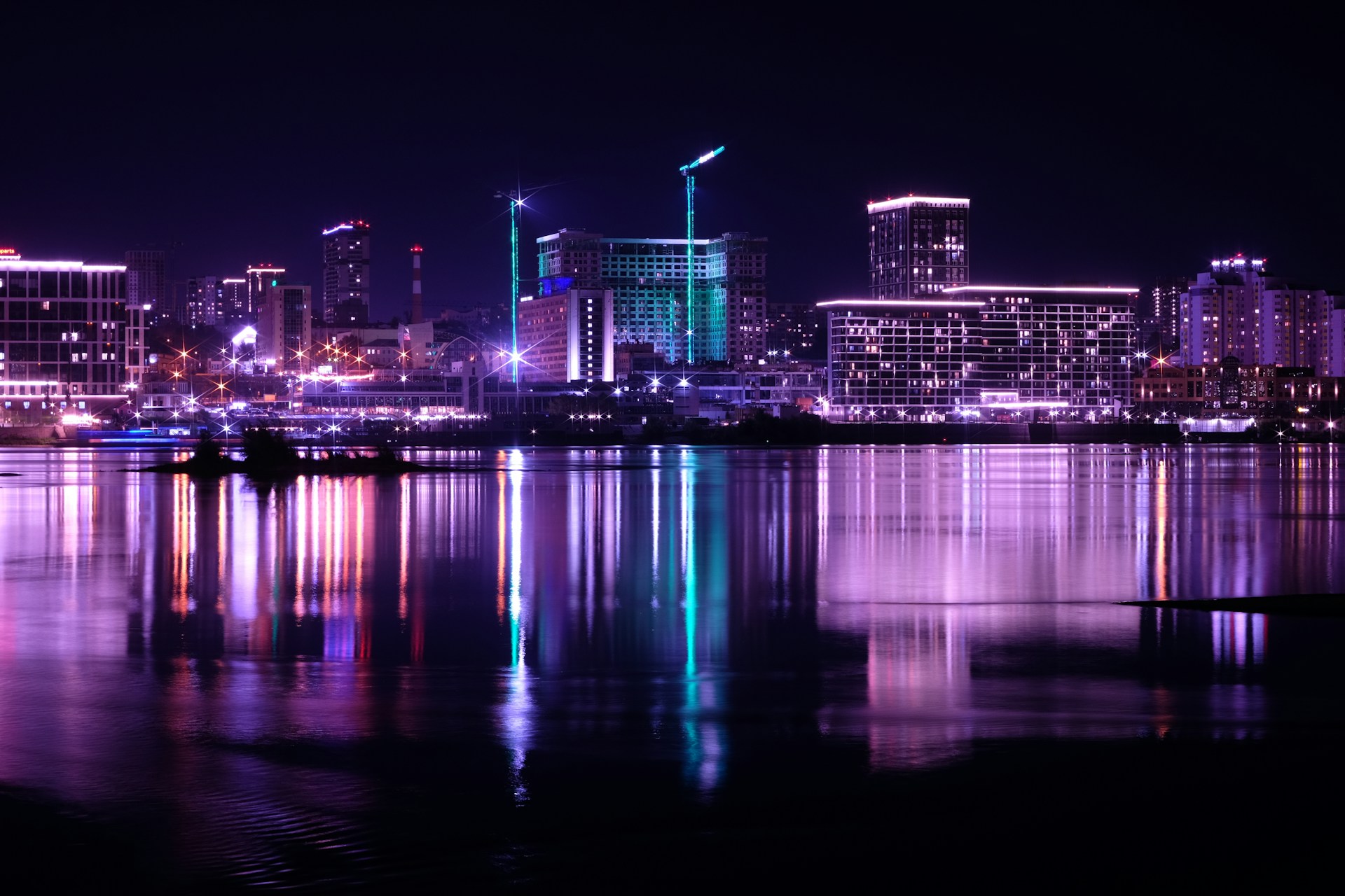 A city skyline is lit up at night