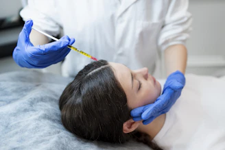 A woman getting her hair done by a hair stylist