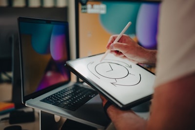 A person is writing on a tablet with a pen