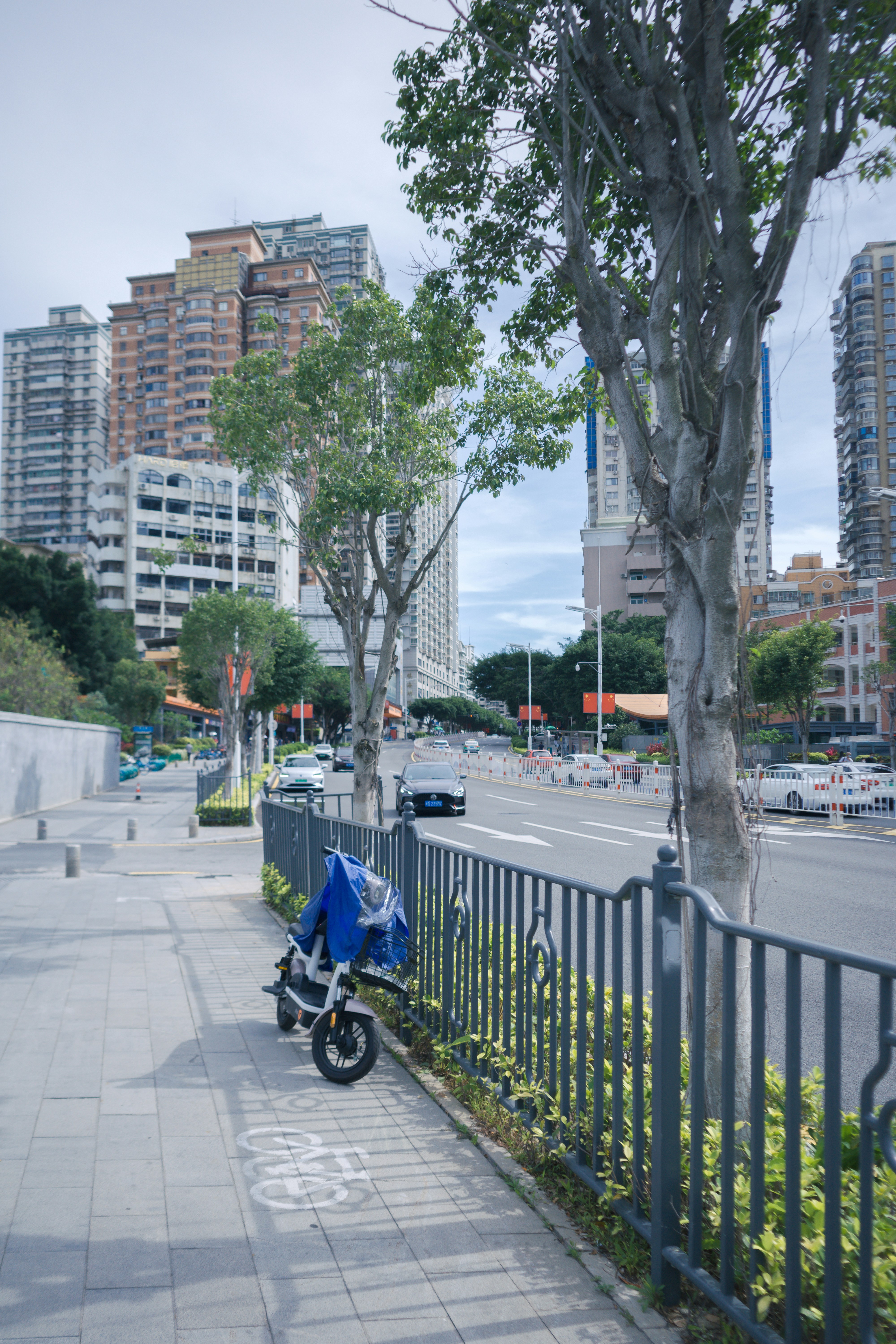 White modern electric scooter parked on clean city sidewalk with bright white background and minimalist urban architecture