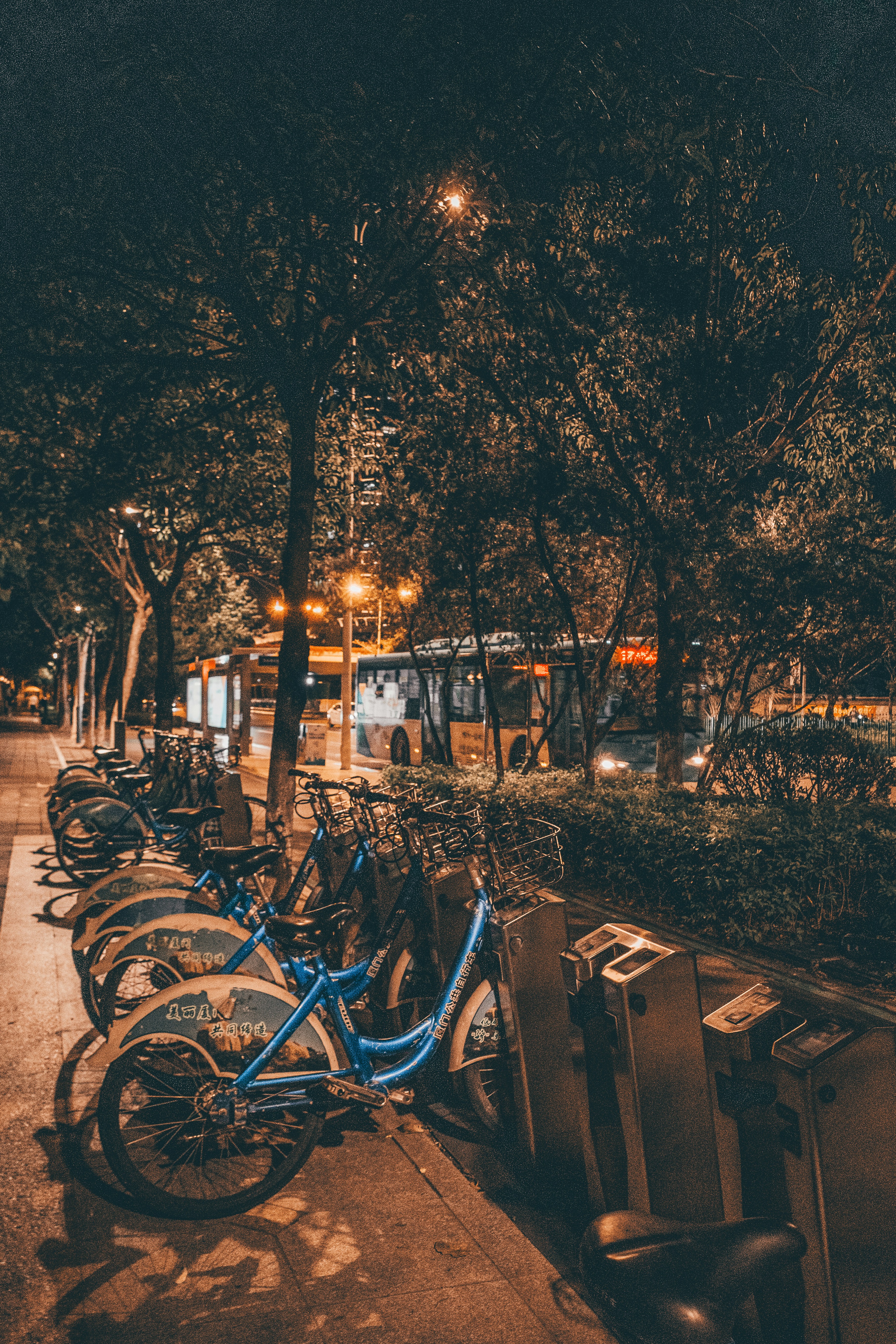 A row of bicycles parked next to each other on a sidewalk