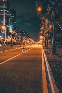A person walking down a street at night