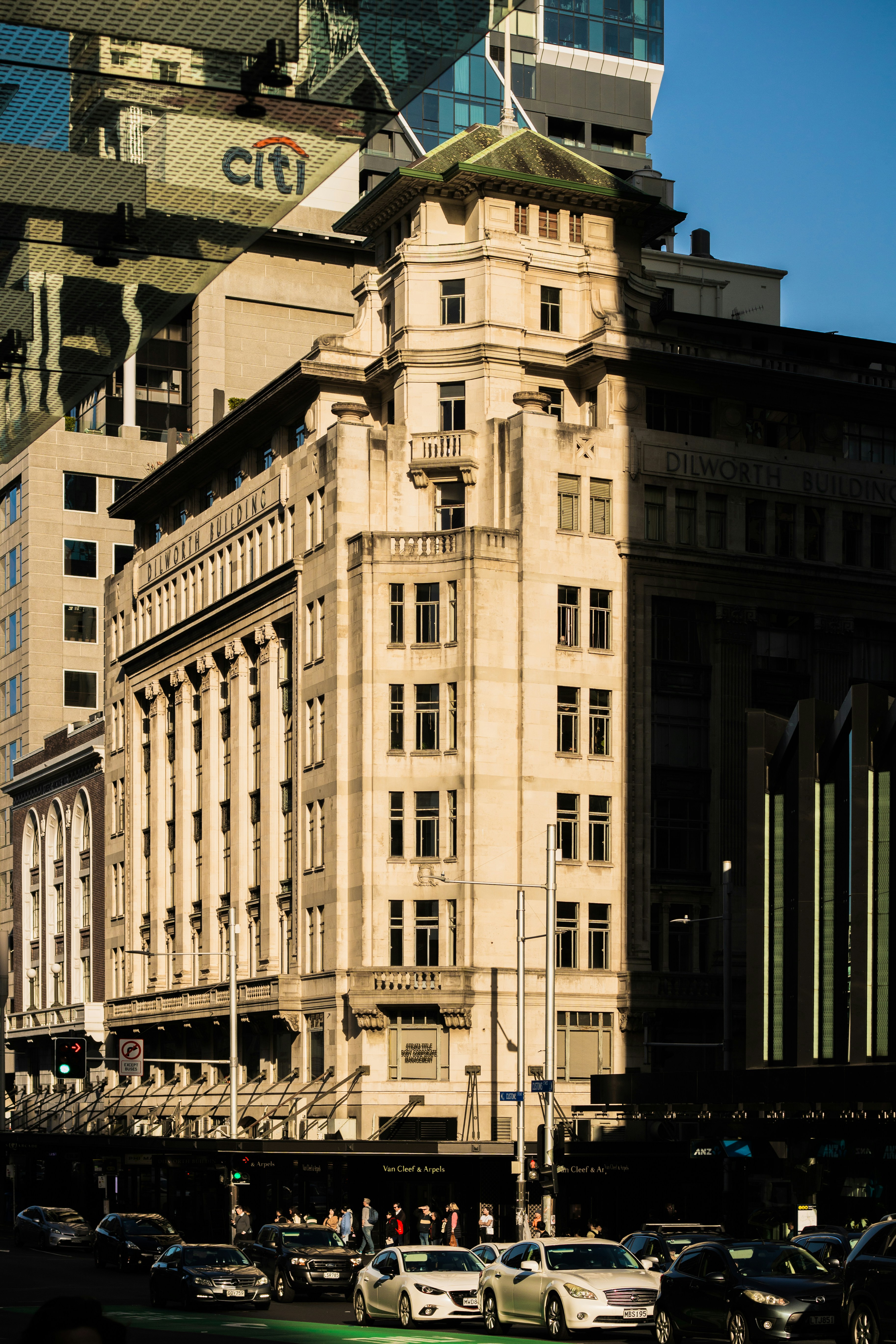 A very tall building with a lot of cars parked in front of it