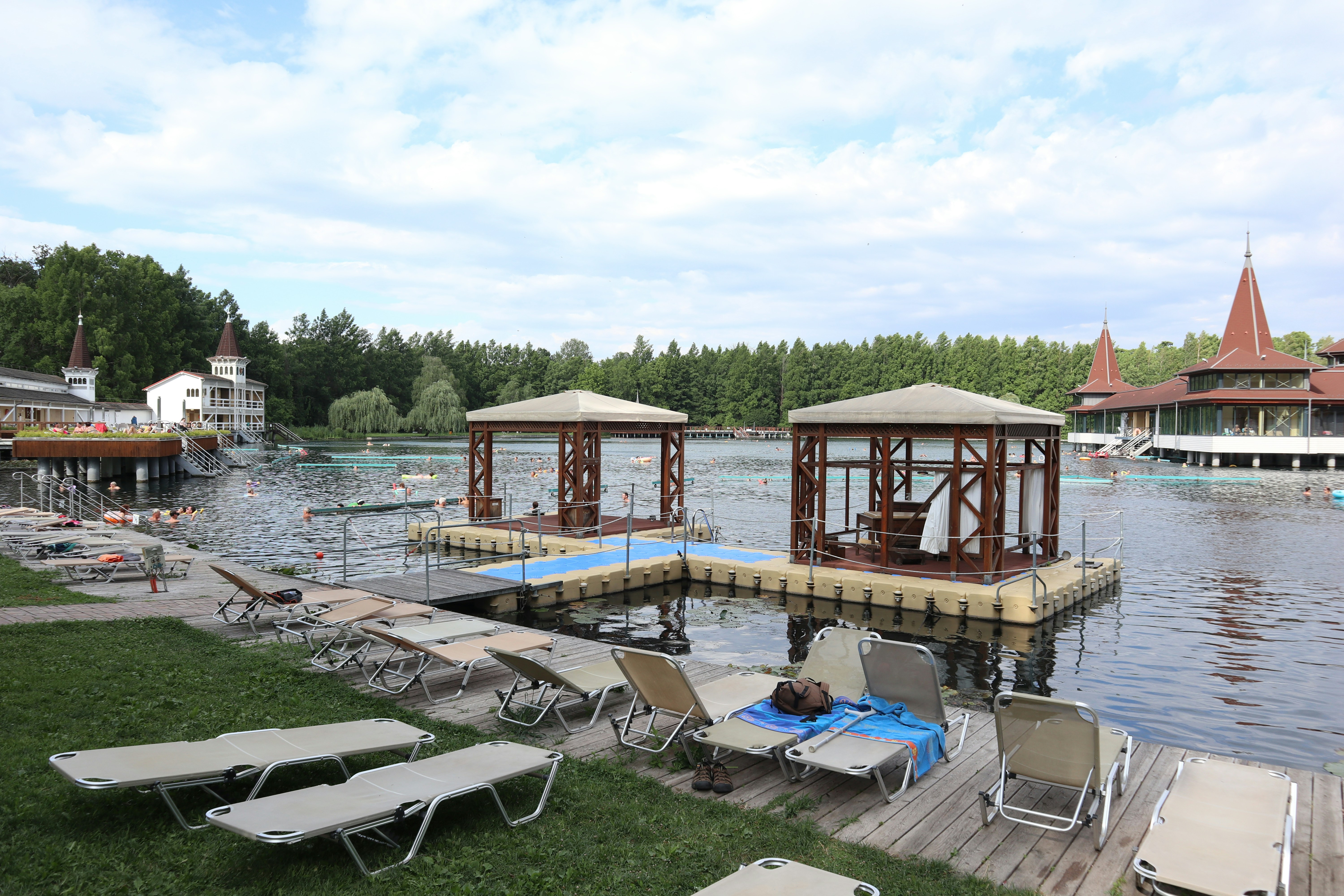 A row of lawn chairs sitting next to a body of water