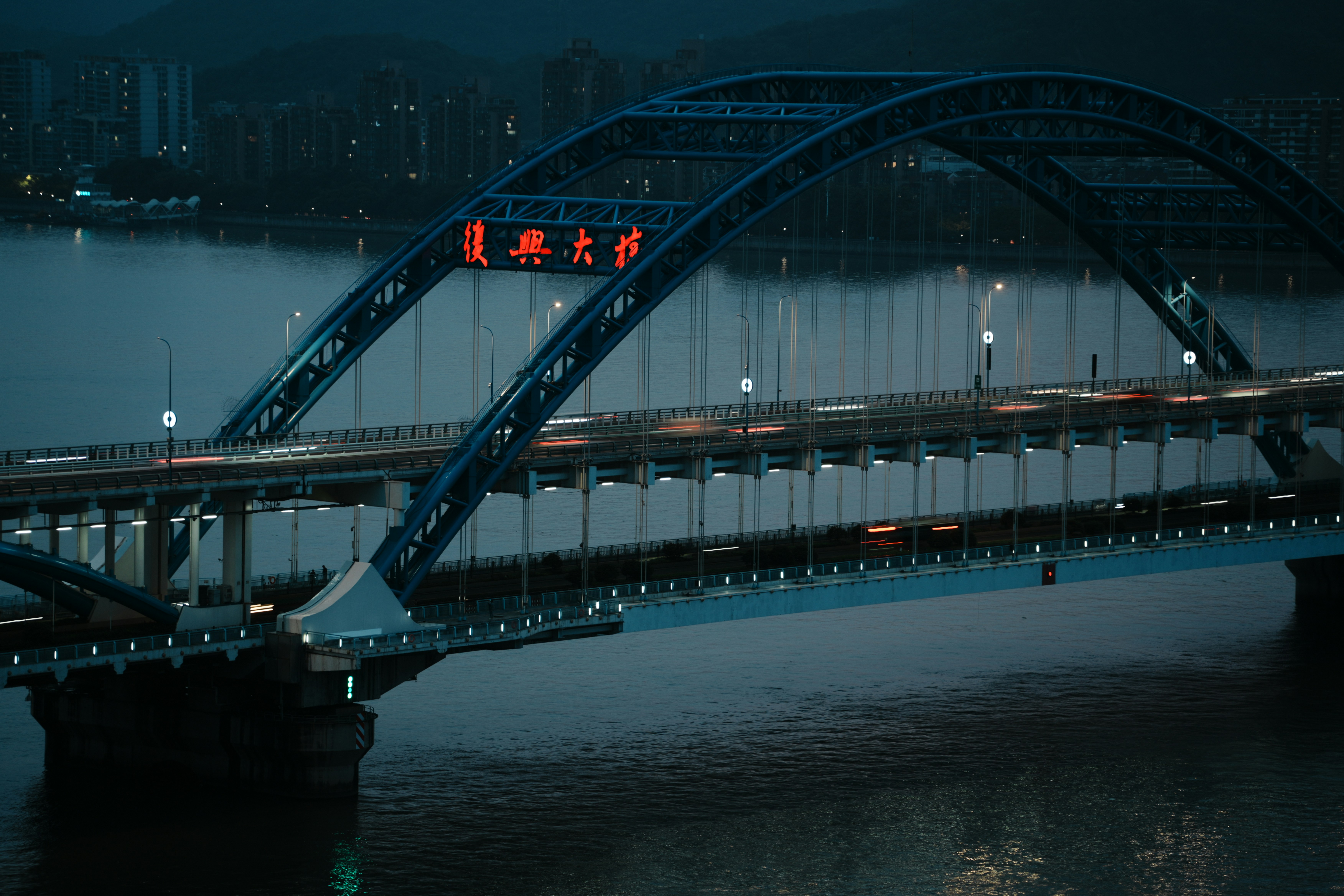 A bridge over a body of water at night