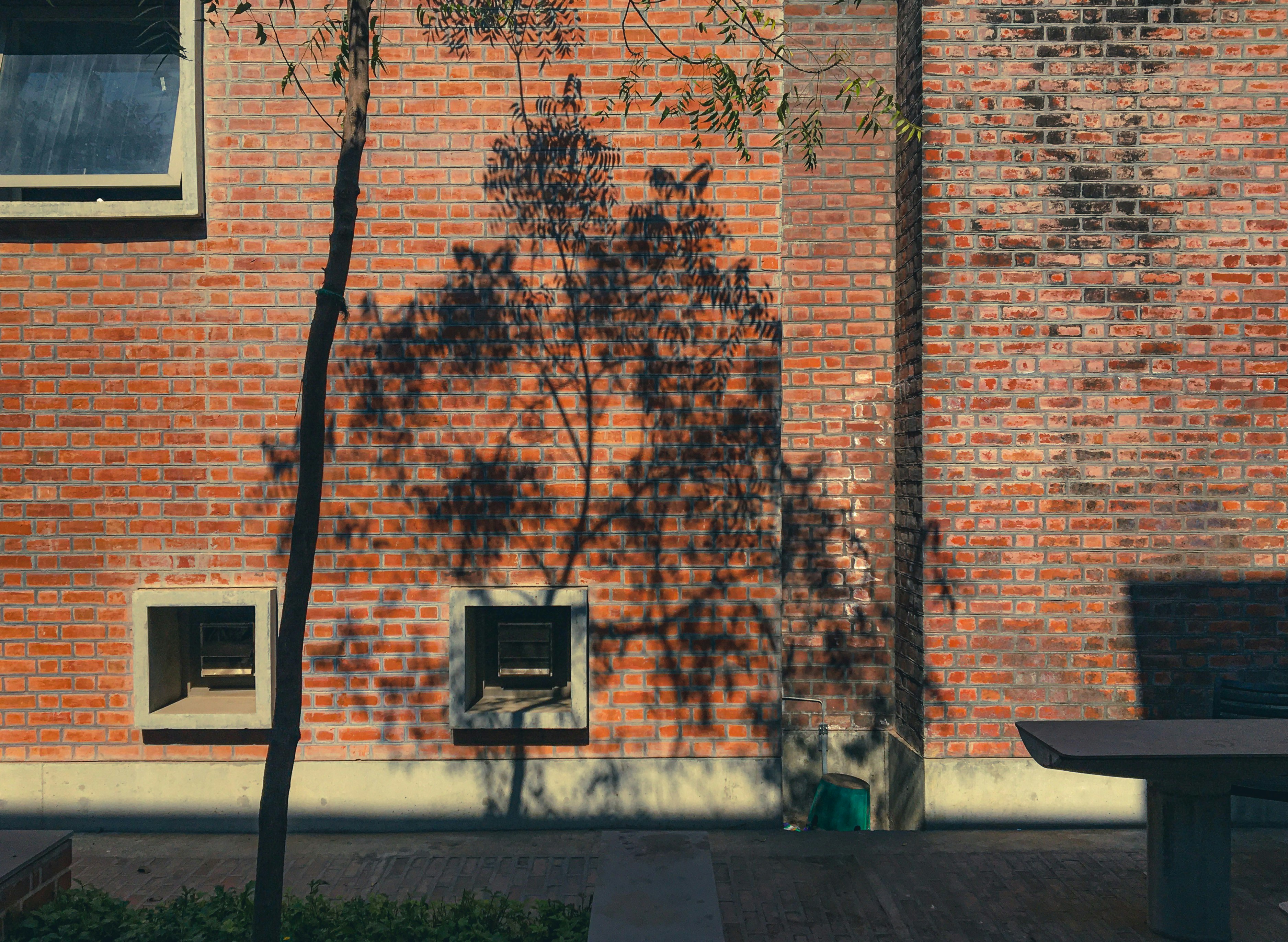 Bench in front of brick building in community