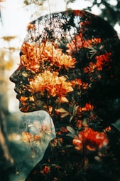 A double exposure of a woman's face with flowers in her hair