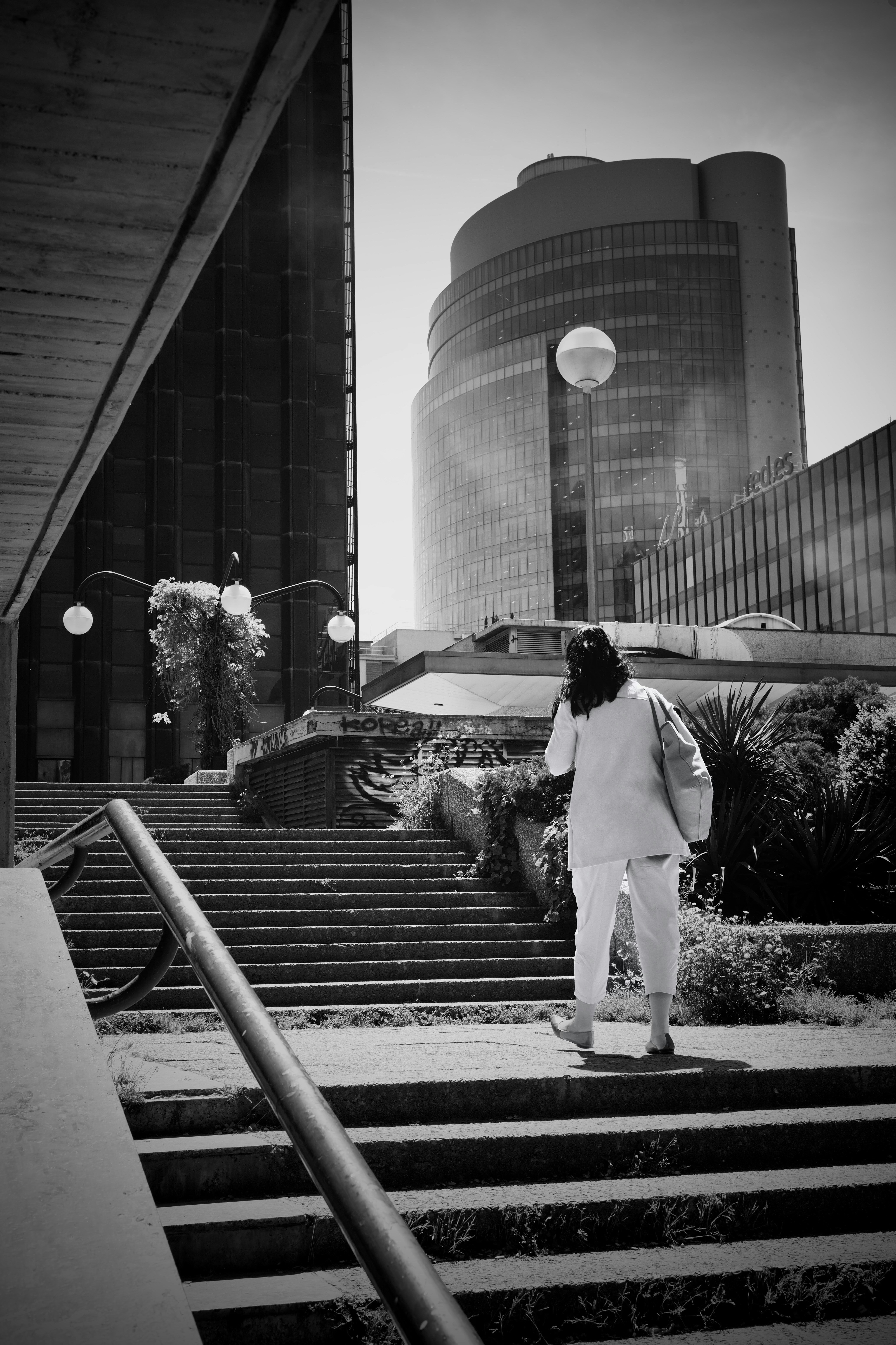 A person walking up some steps in front of a building