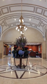 A lobby with a chandelier and a marble floor