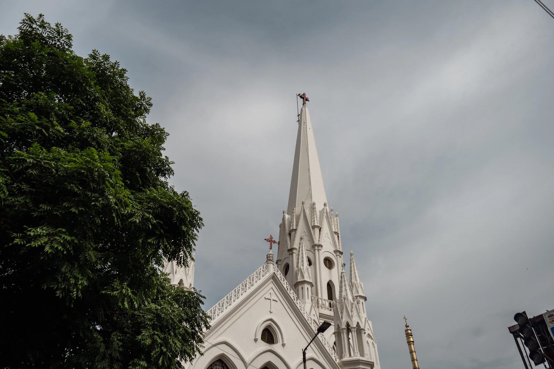 A church steeple with a cloudy sky in the background