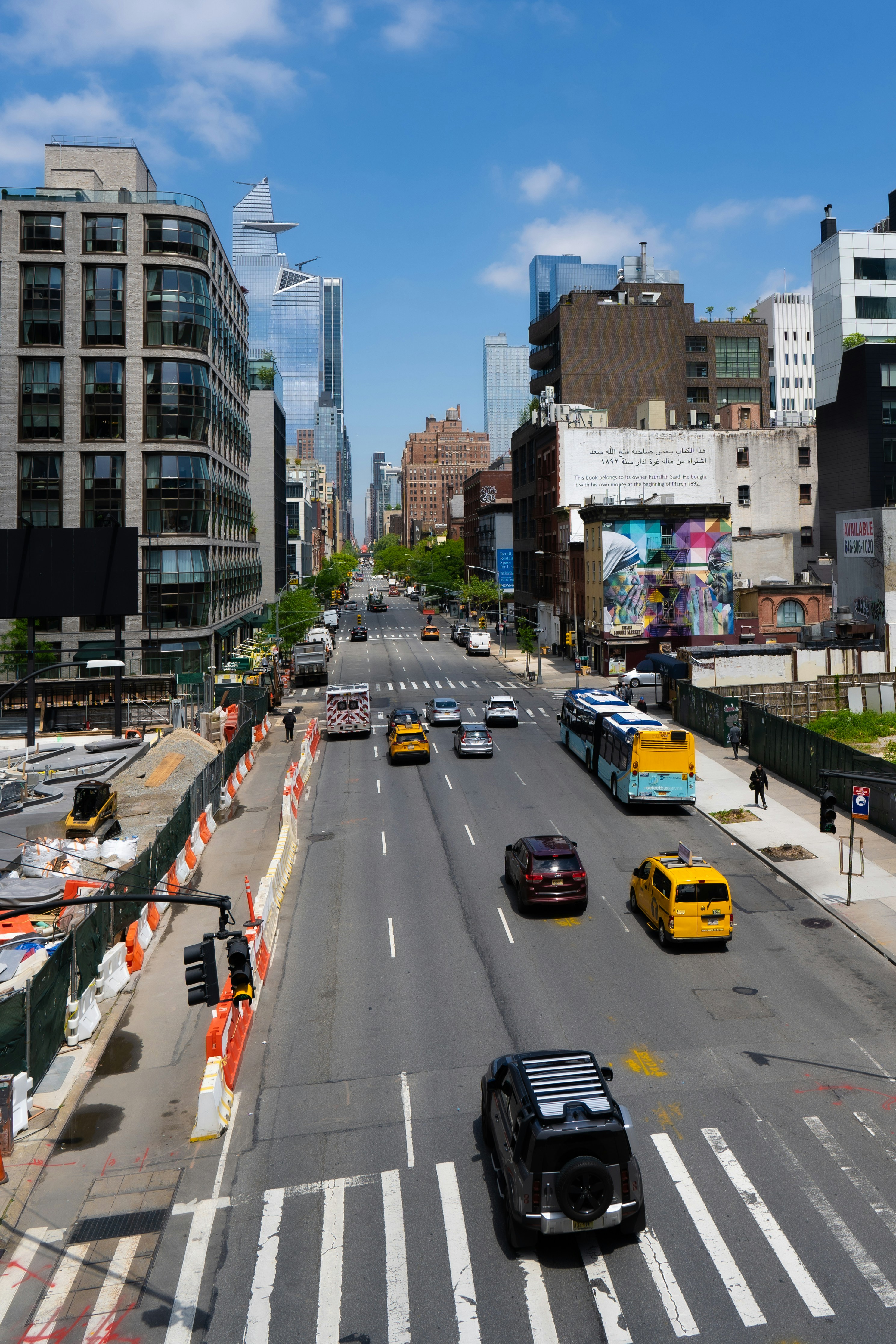 A city street filled with lots of traffic next to tall buildings