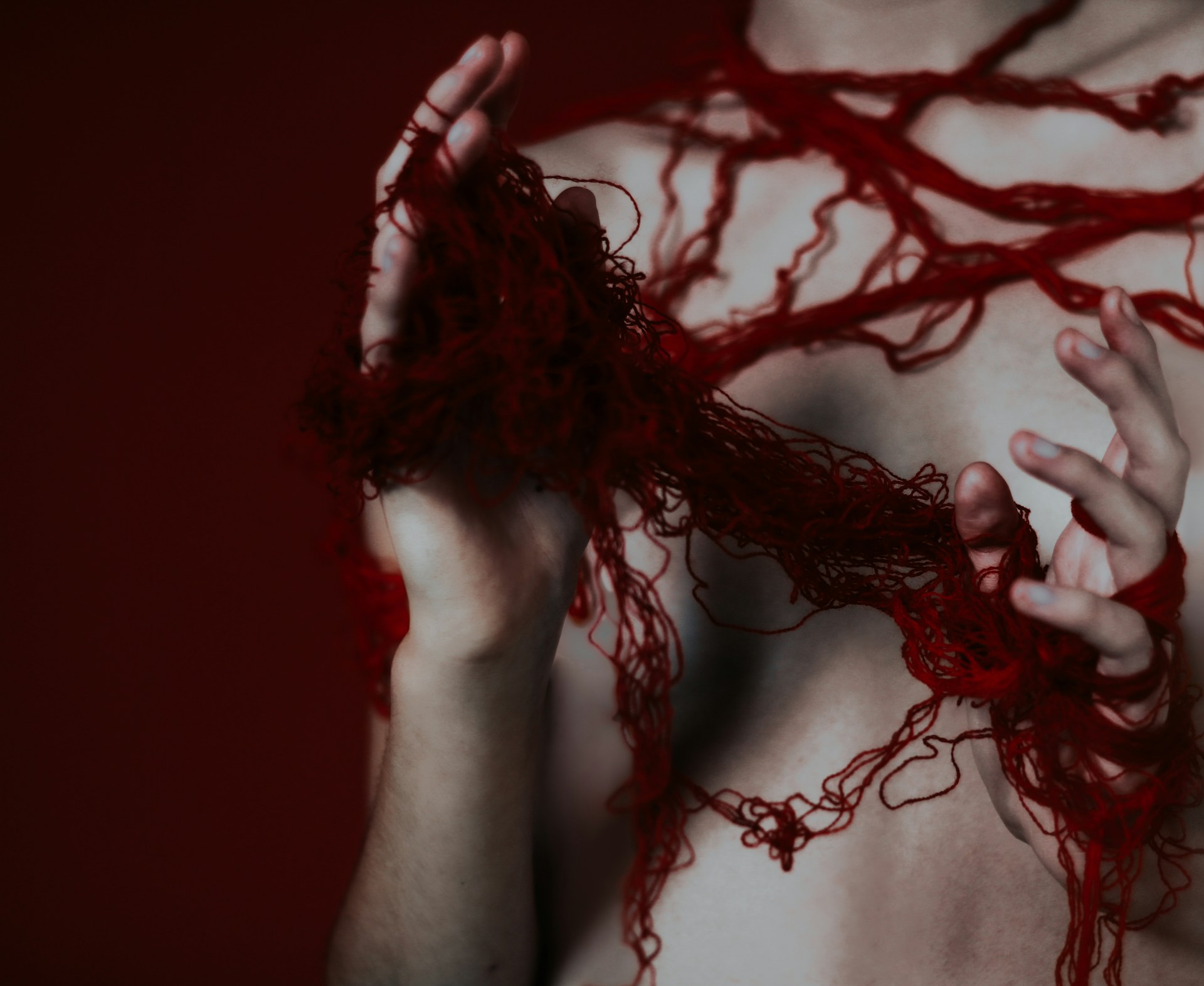 A man with blood on his body and hands