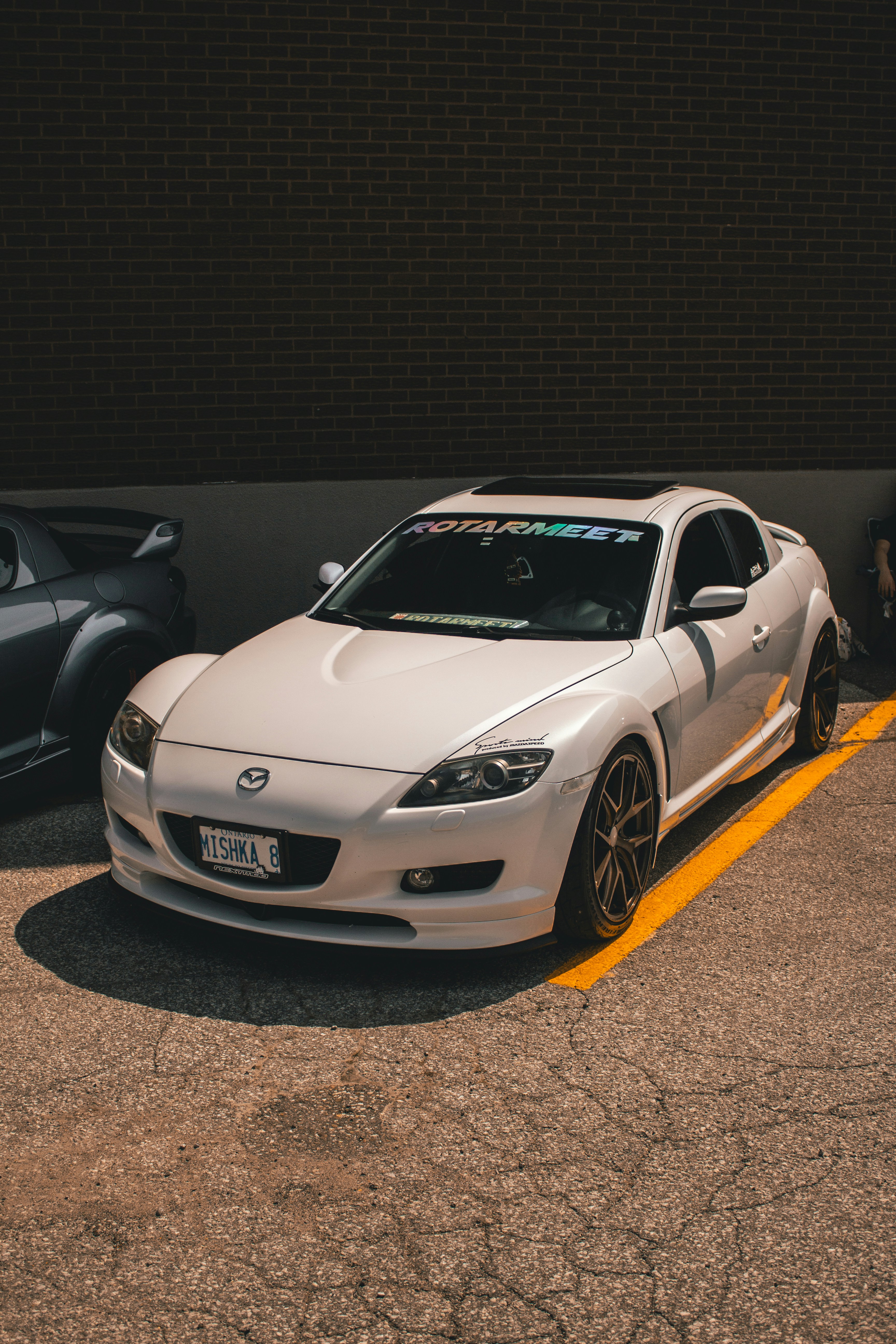 Two cars parked in a parking lot next to each other