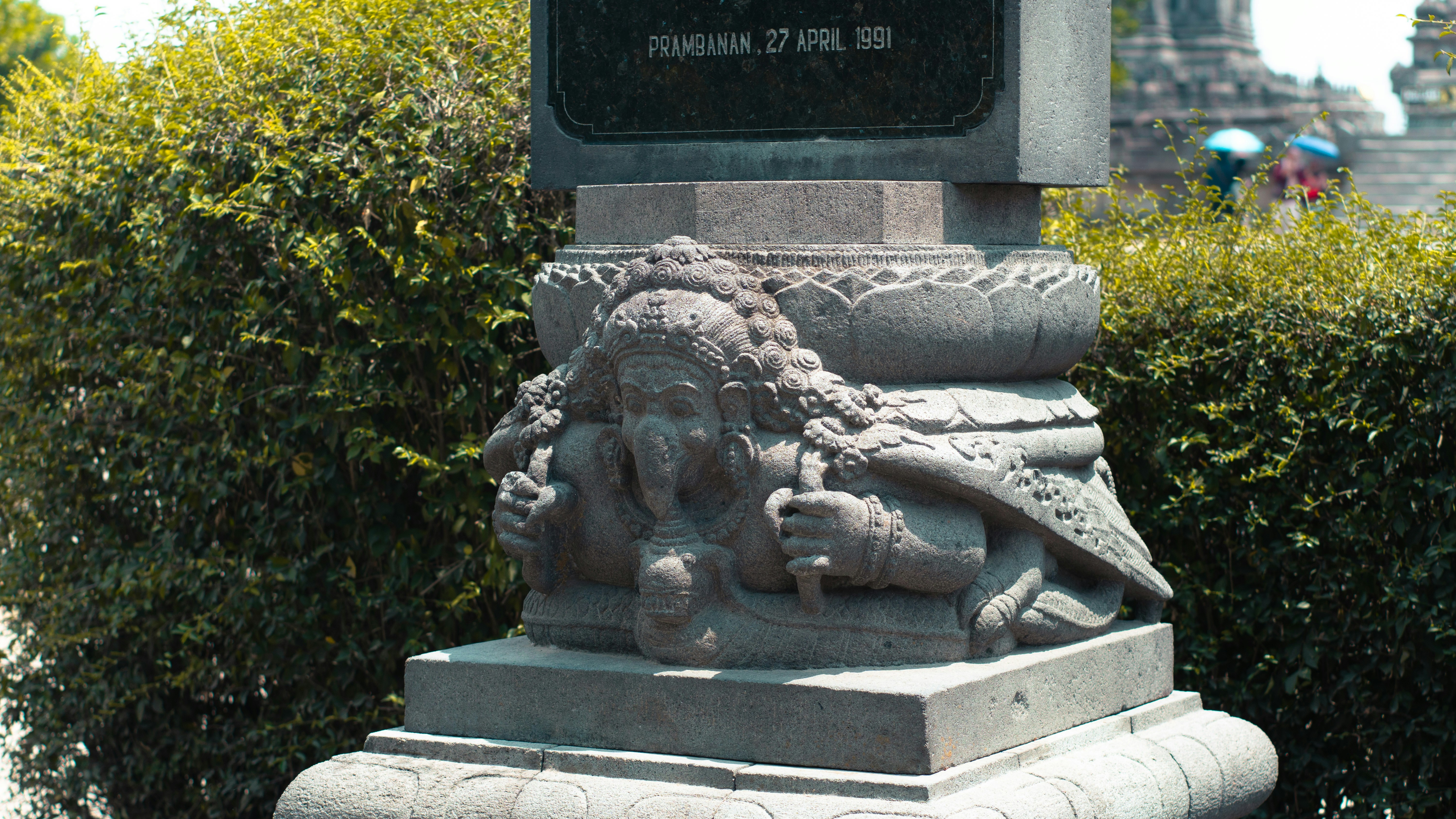 A statue with a clock on top of it