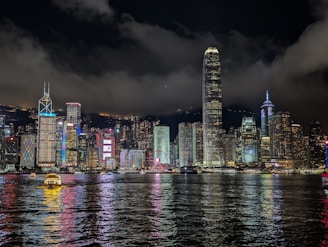 A view of a city at night from the water