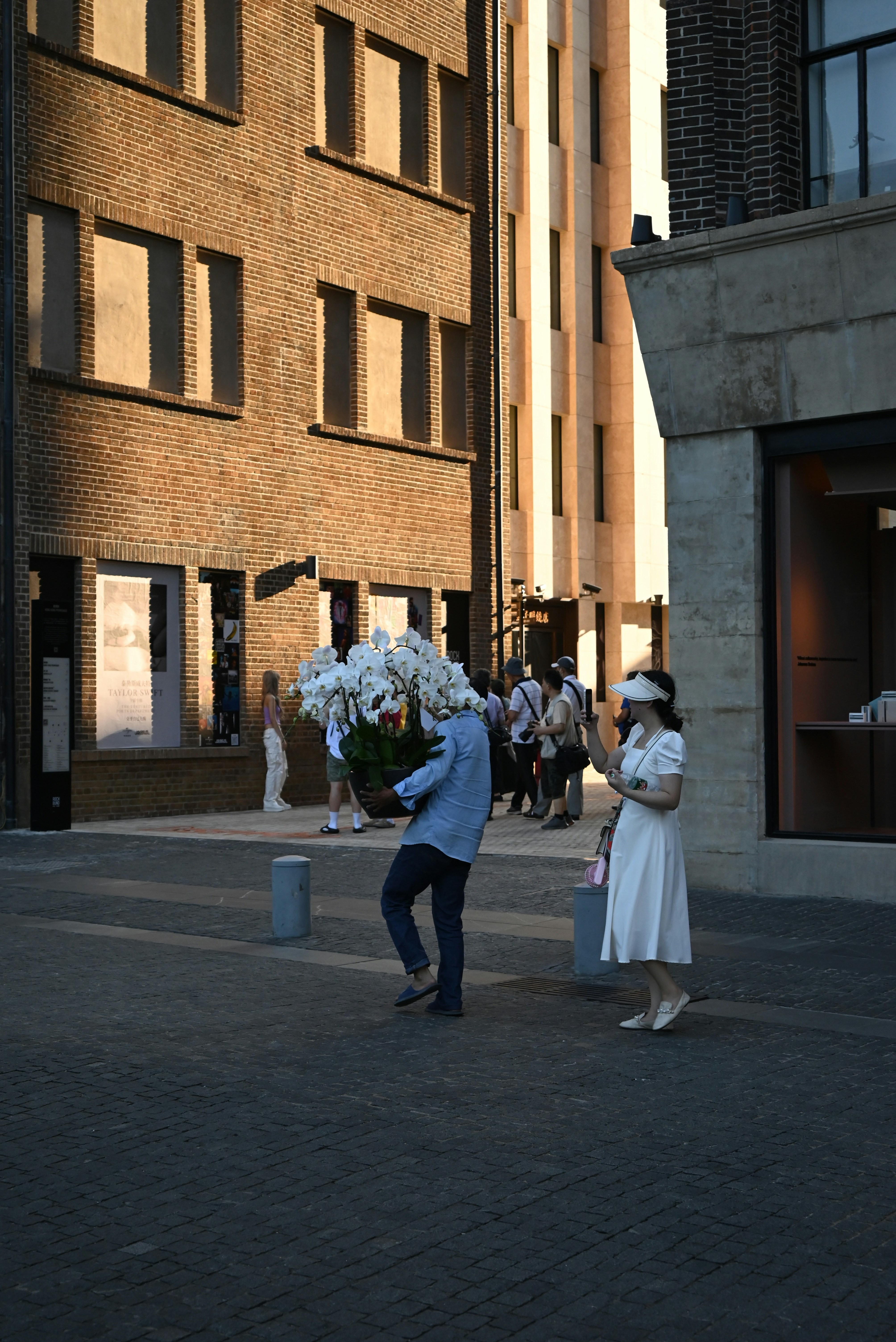 A man and a woman standing in front of a building