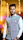 A man standing in a room with lights in the background